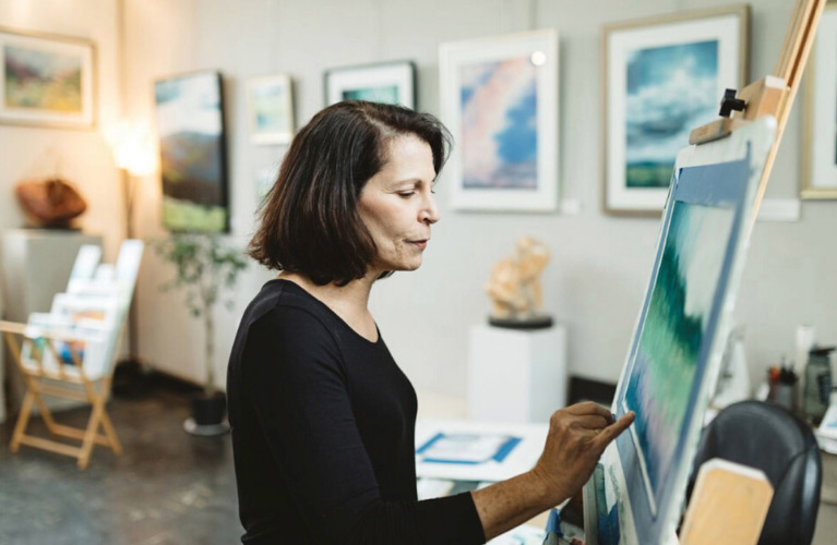 Elise Okrend painting at her easel